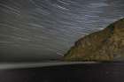 Iceland, Vik. Myrdal. Star trails above Reynisfjara black sand beach at night Art Print